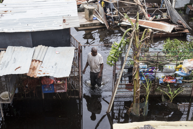 A resident of Loiza, Puerto Rico, wades through flood water days after Hurricane Maria made landfall, on Sept. 22, 2017. (Alex Wroblewski/Getty Images)
